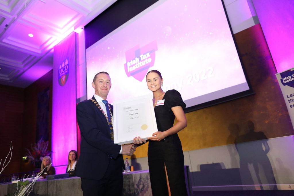 Colm Browne, Institute President, handing Alisha Scollan her Third-Level Scholarship.