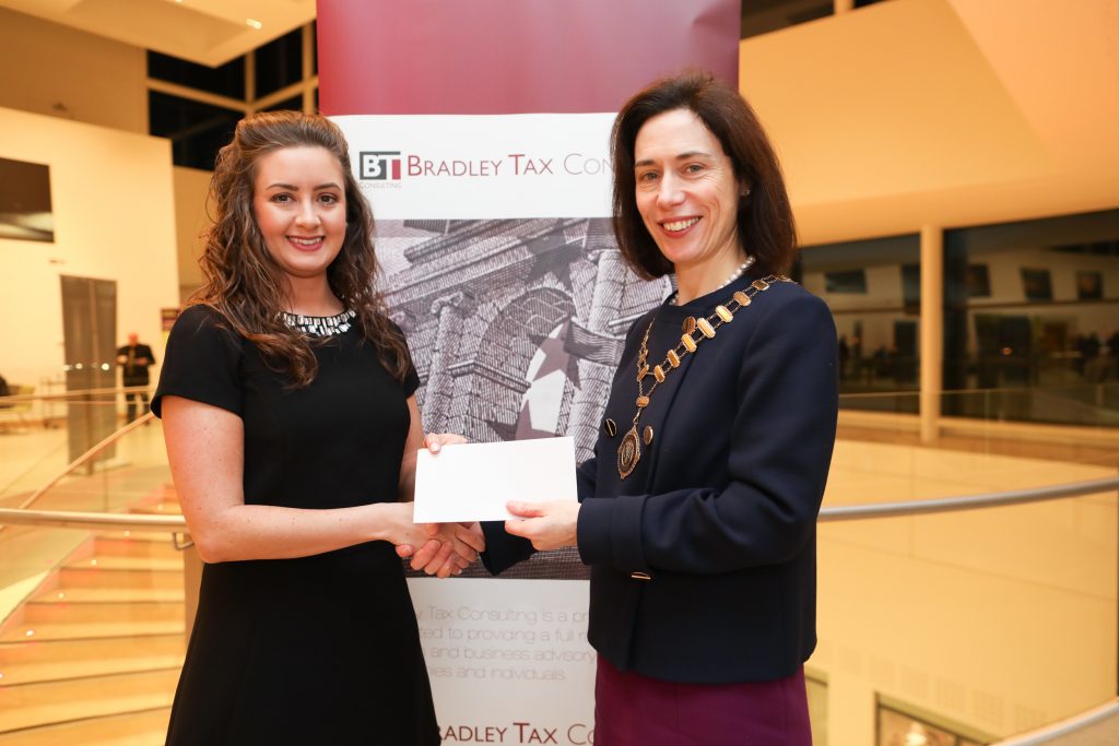 Claire Doyle receiving the prize for Joint Highest Marks at Part 2 Personal Taxes Exam from Marie Bradley, Institute President and Managing Director, Bradley Tax Consulting.