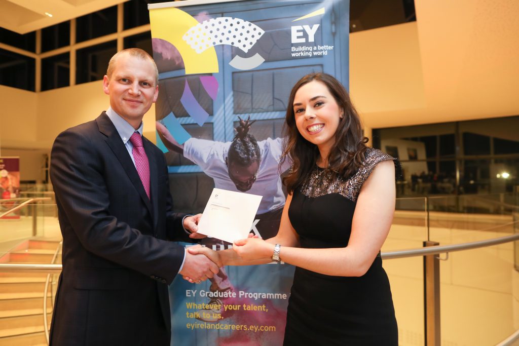 Martha McCormack receiving the prize for Highest Marks at Part 3 Advanced Indirect Taxes Exam from Ian Collins, Partner, EY.