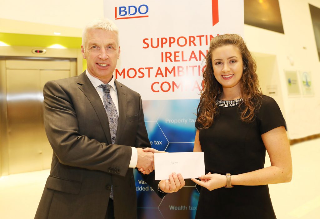 Claire Doyle receiving the prize for Outstanding Marks at Part 2 from Ciarán Medlar, Partner & Head of Tax, BDO.