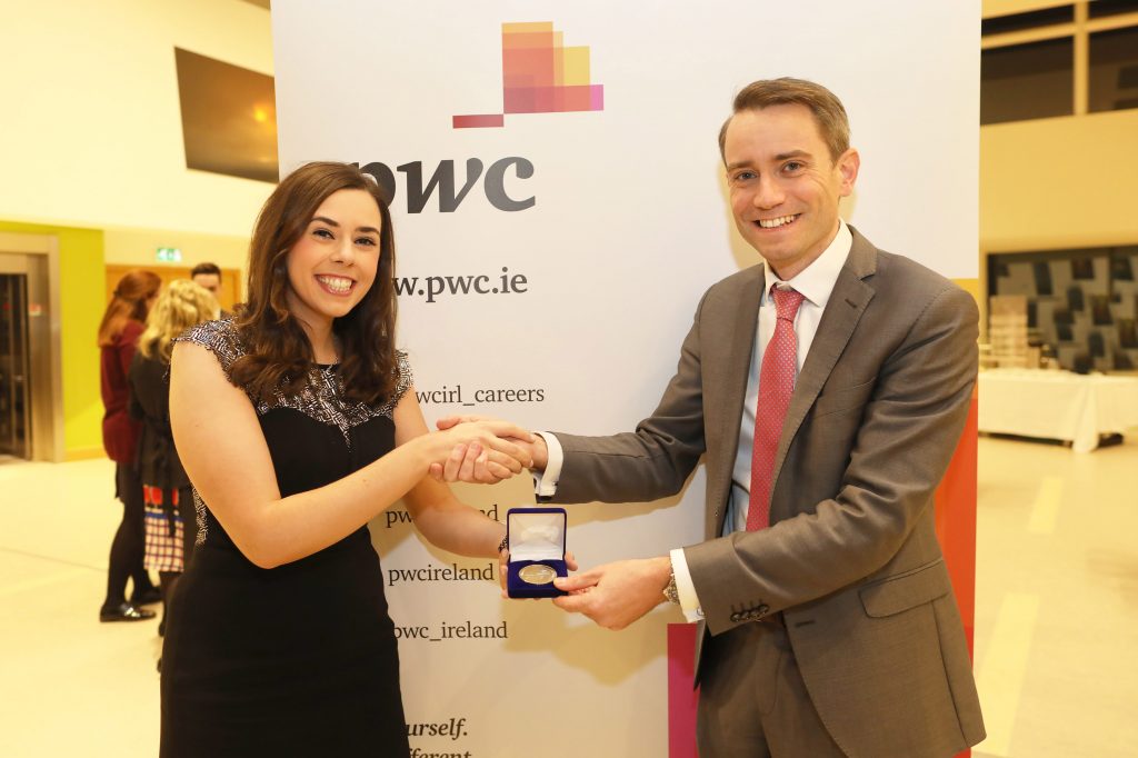 Martha McCormack receiving the Vincent O’Leary Memorial Medal for Exceptionally High Standard in Part 3 from Colm O’Callaghan, Partner, PwC.
