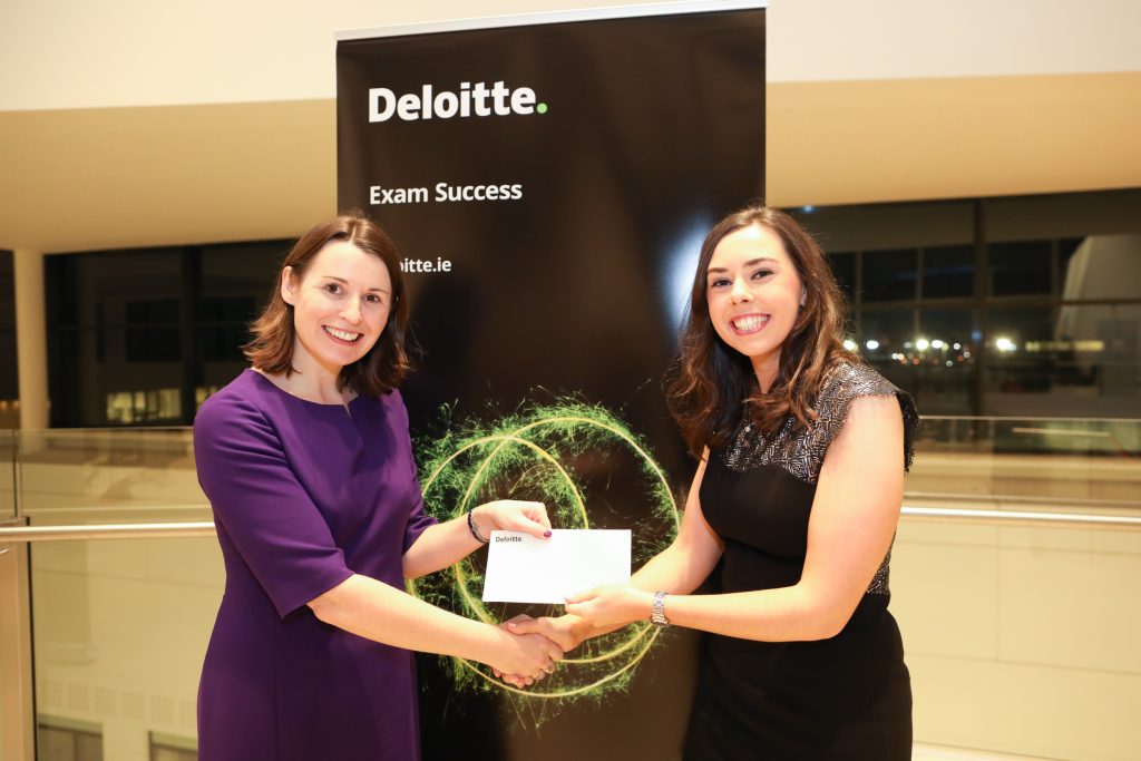 Martha McCormack receiving the prize for Highest Marks at Part 3 Advanced Direct Tax: Domestic Exam from Louise Kelly, Partner – Tax, Deloitte.