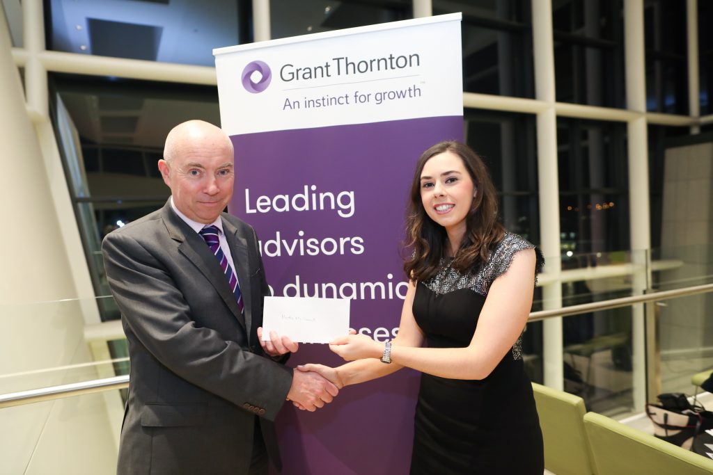 Martha McCormack receiving the prize for Exceptionally High Standard at Part 3 Advanced Direct Tax: Domestic from Michael McGivern, Grant Thornton.