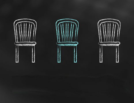 5 chairs drawn on a chalkboard with one coloured in blue representing the job opportunity.